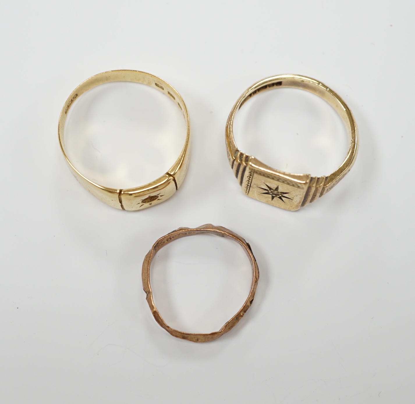 A 1930's 18ct gold signet ring (stone missing), 7.4 grams and two 9ct gold rings including diamond chip set signet ring, gross weight 6.2 grams.